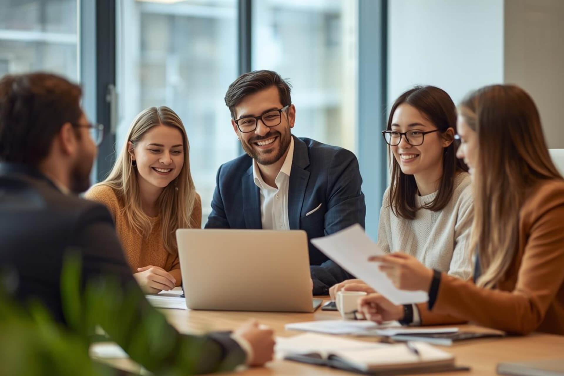 Colleagues collaborating in an office setting, representing teamwork in language learning and TOEIC test preparation.
